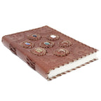Brown leather notebook with embossed designs on a white background