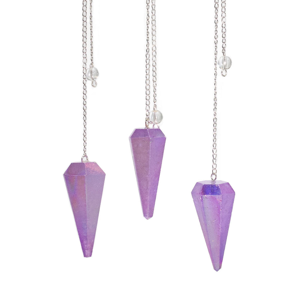 Three purple crystal pendulums on silver chains against a white background