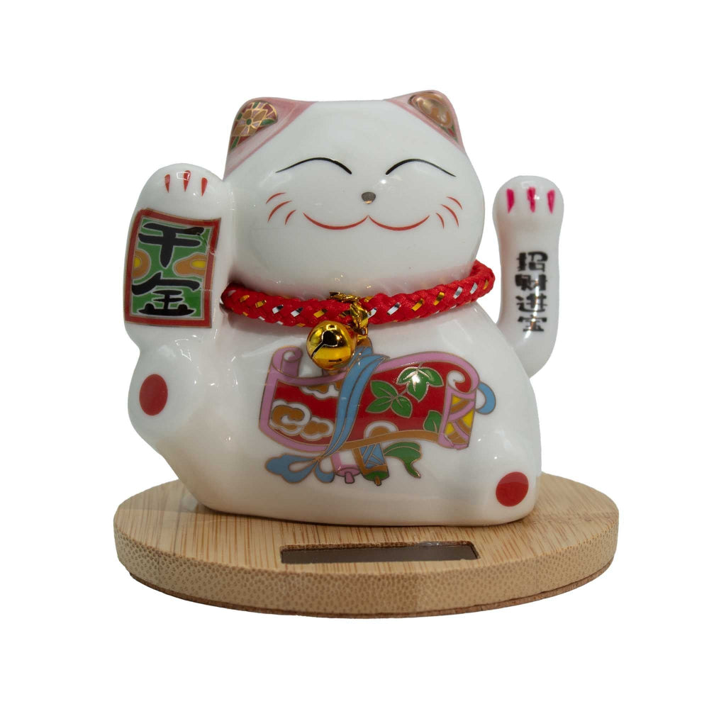 Decorative ceramic cat figure with colorful design on a white background