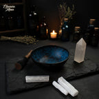 Blue ceramic bowl with engraved design on a wooden surface with natural elements.