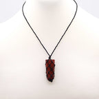 Necklace with a red pendant on a white background