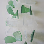 Green and clear glass碎片 on a white background