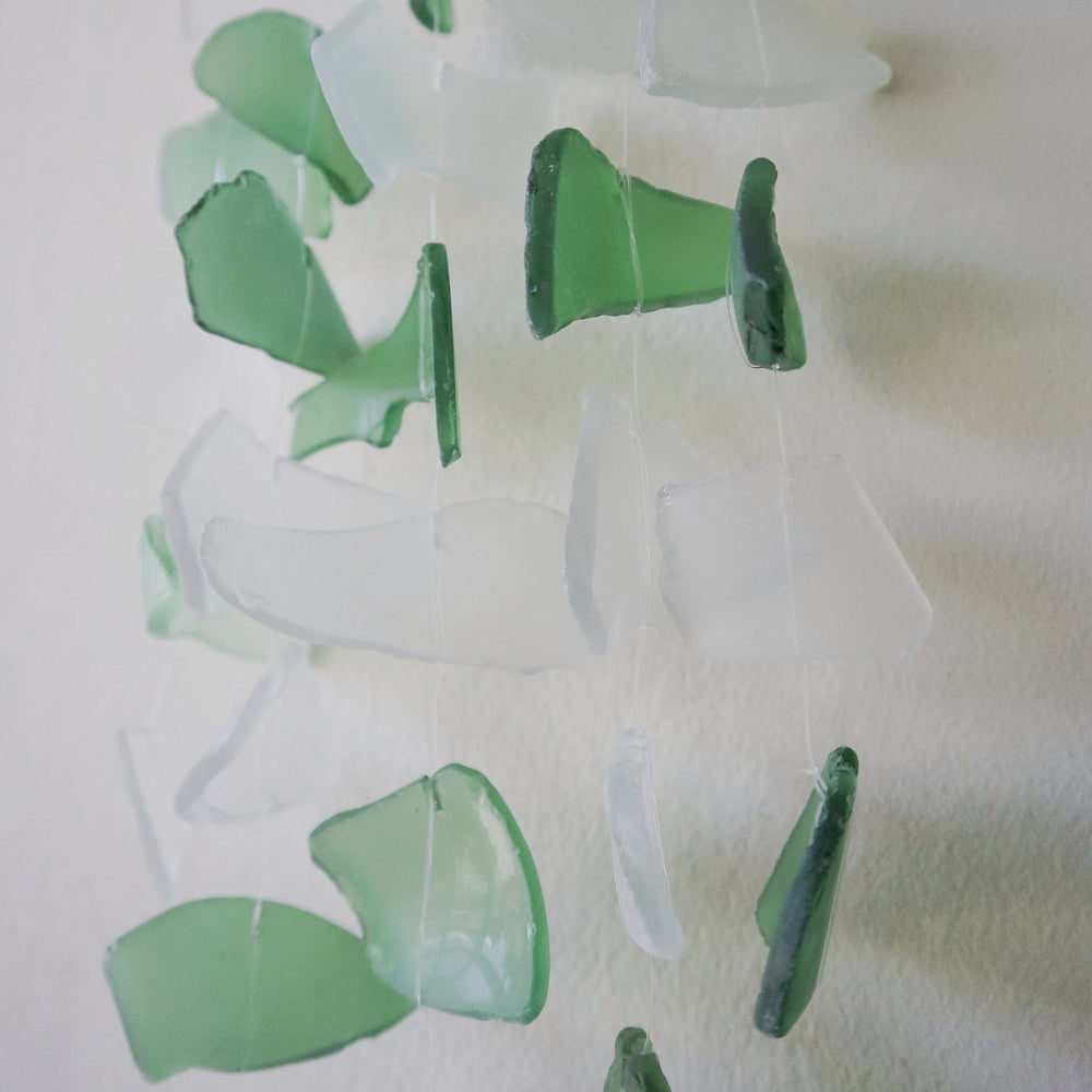 Green and clear glass碎片 on a white background