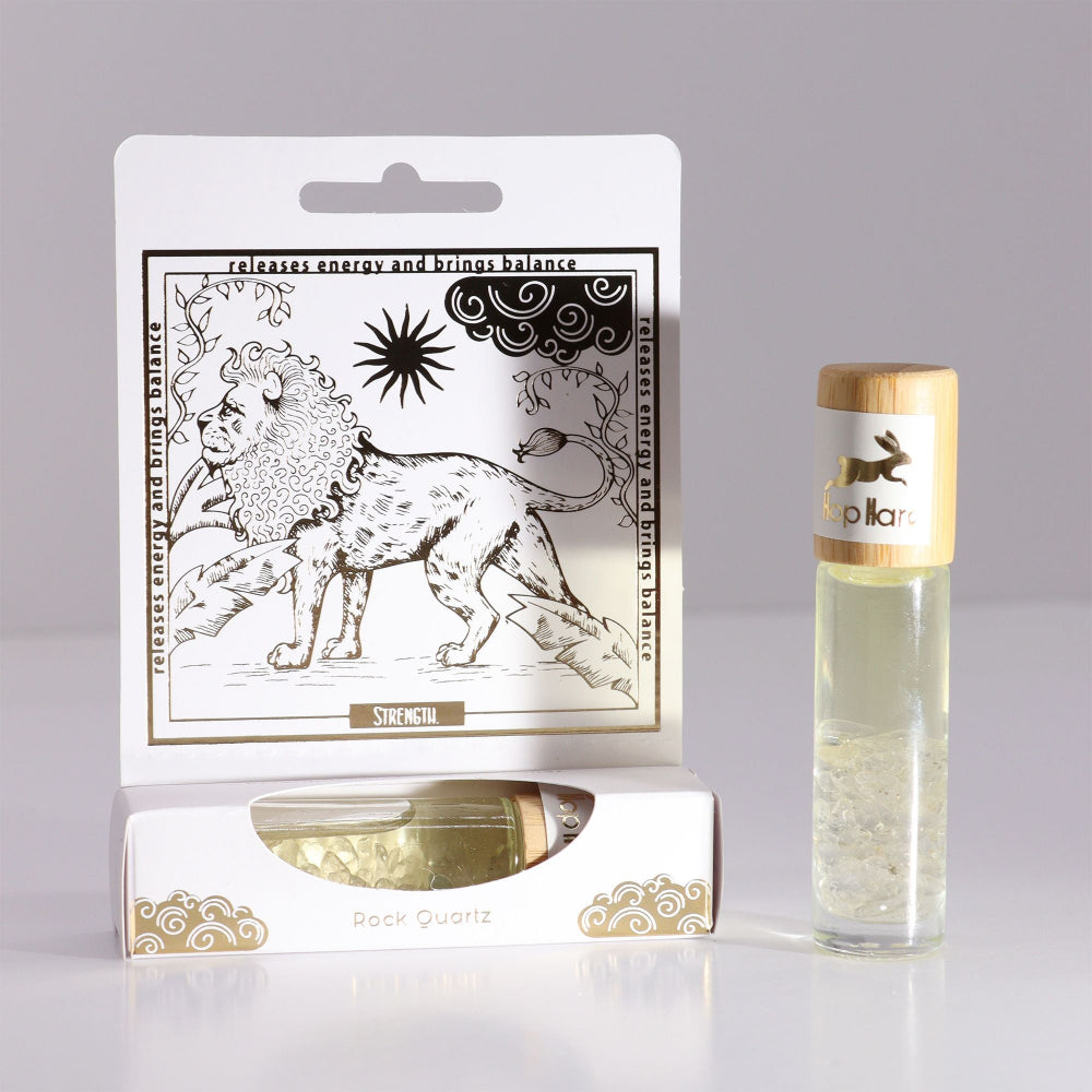 Product packaging with a lion illustration and a glass bottle with a wooden cap on a gray background