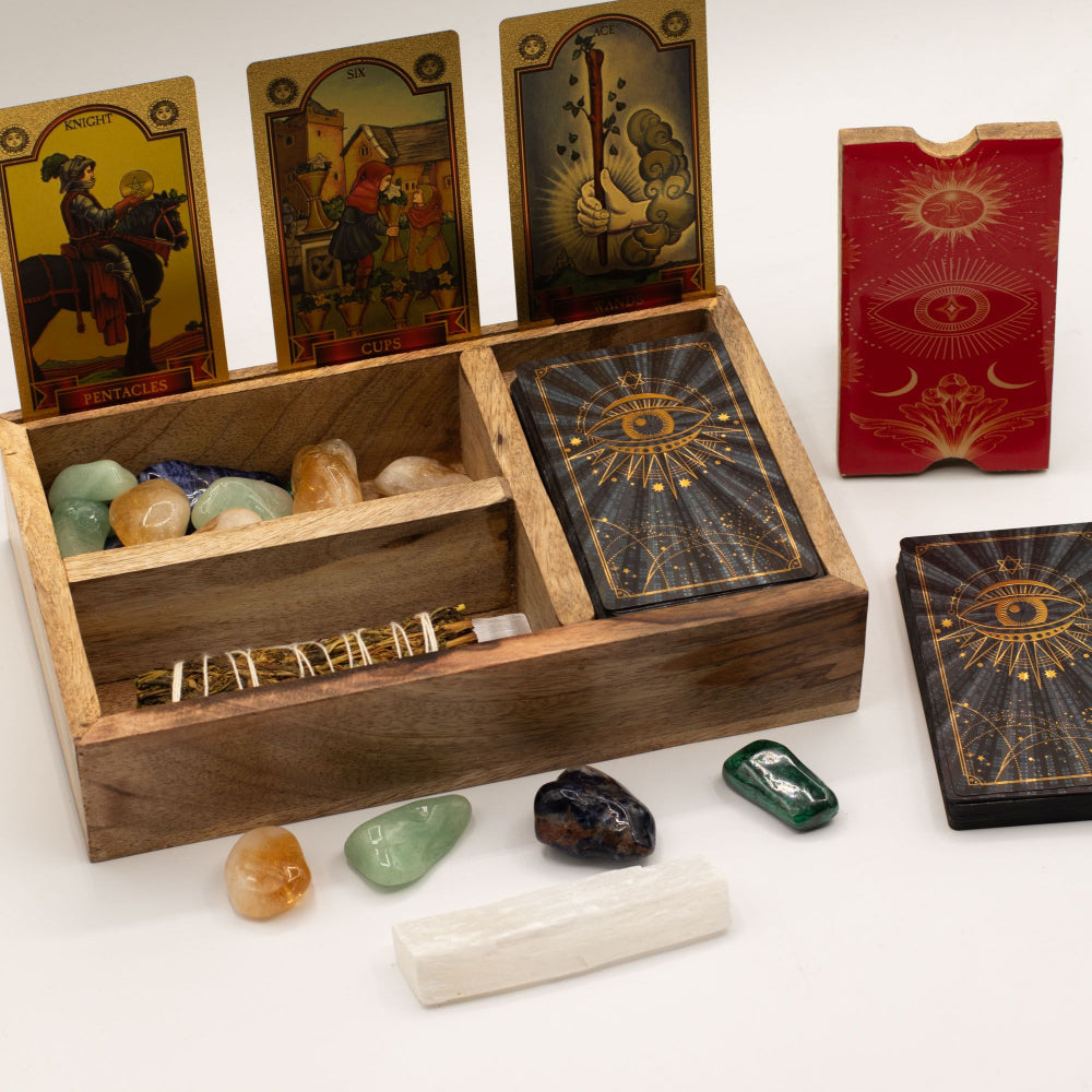 Wooden box with tarot cards, crystals, and a candle on a white background