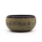 Green ceramic bowl with black interior and text on a white background