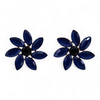 Pair of blue flower-shaped earrings with a black center on a white background