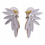 Pair of white floral earrings with gold accents on a white background