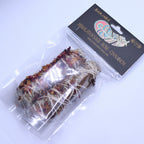 Packaged bundle of herbs with a label on a white background