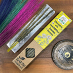 Palo Santo with Chamomile smudge incense on a wooden surface with packaging and tools.
