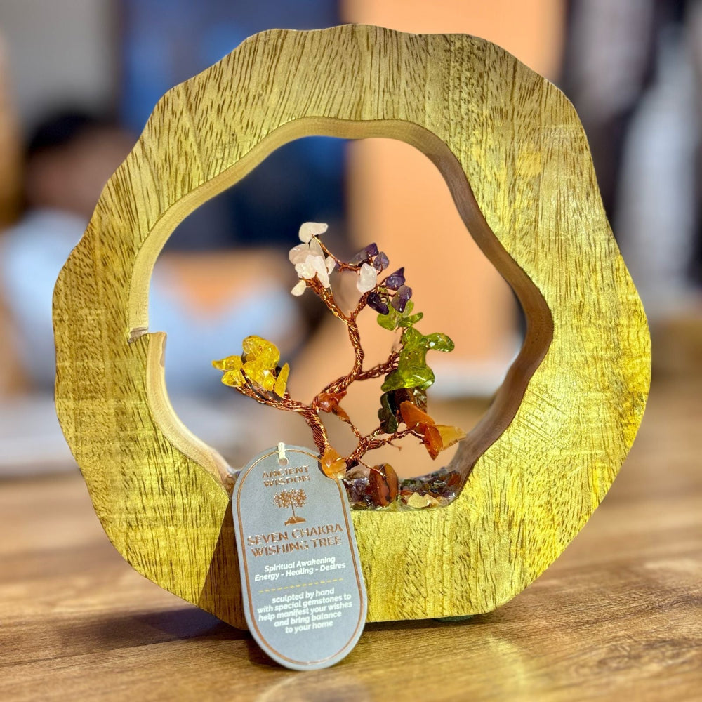 Decorative piece with a tree-like sculpture inside a wooden frame on a wooden surface.