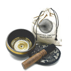 Tibetan singing bowl set with decorative lid, wooden striker, and carrying bag on a white background