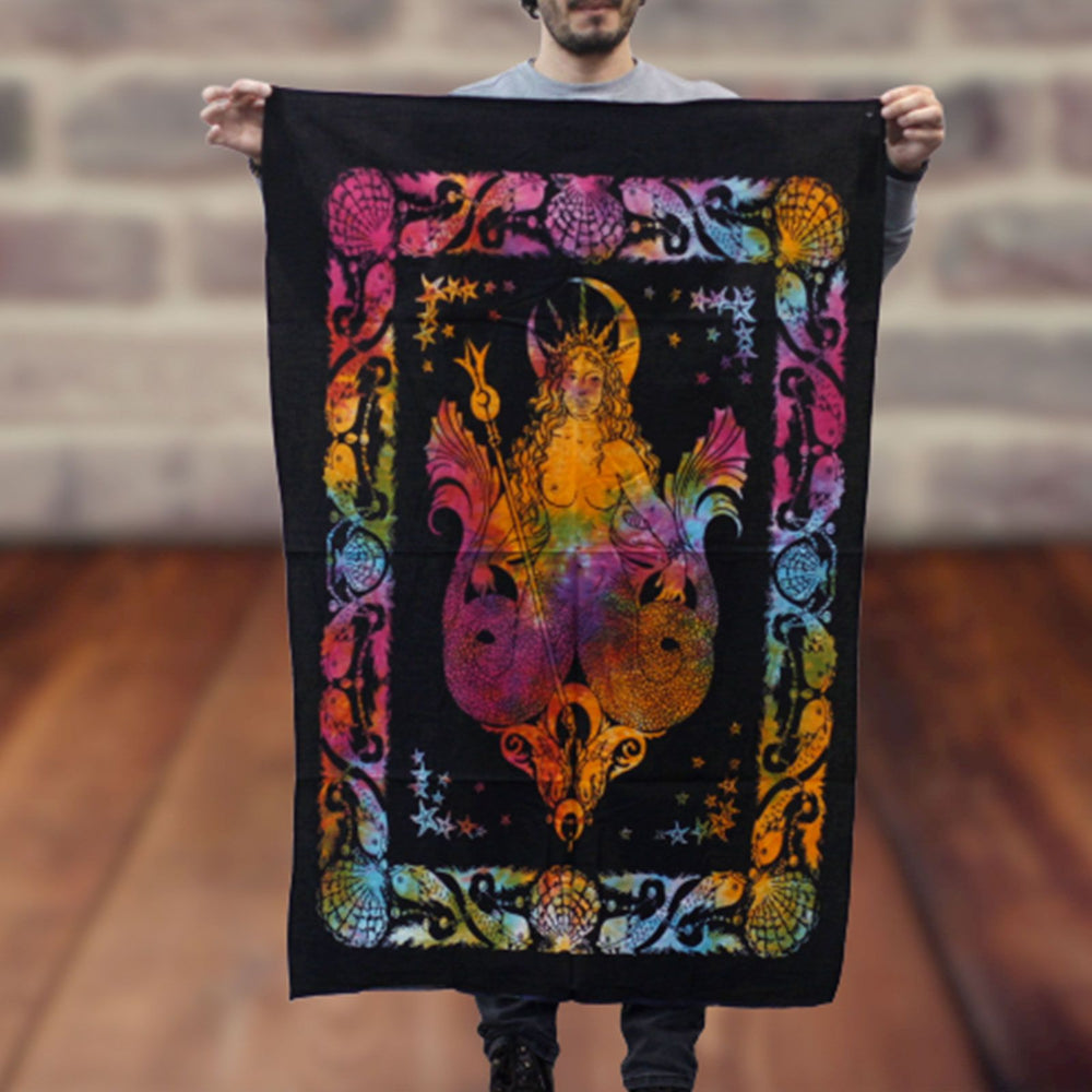 Person holding a colorful tapestry with a fantasy design against a blurred background