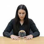 Woman holding a crystal ball in a room with shelves and decor