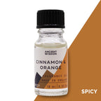 Fragrance oil bottle labelled 'Cinnamon & Orange'  on a white and brown background.
