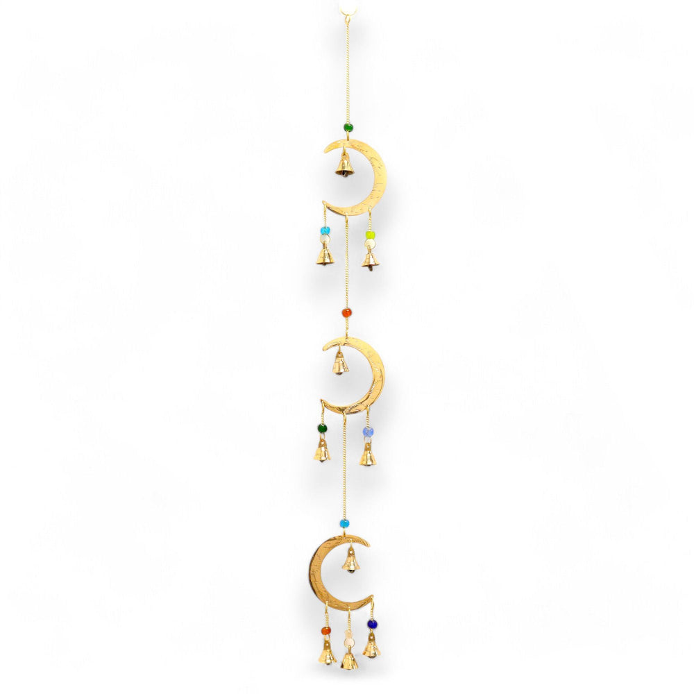 Decorative hanging with moon shapes and colorful beads on a white background