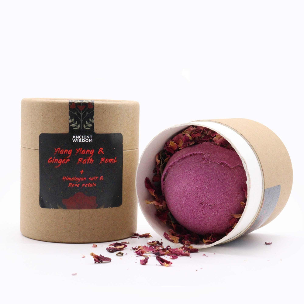 Purple bath bomb in a cardboard container with a label on a white background