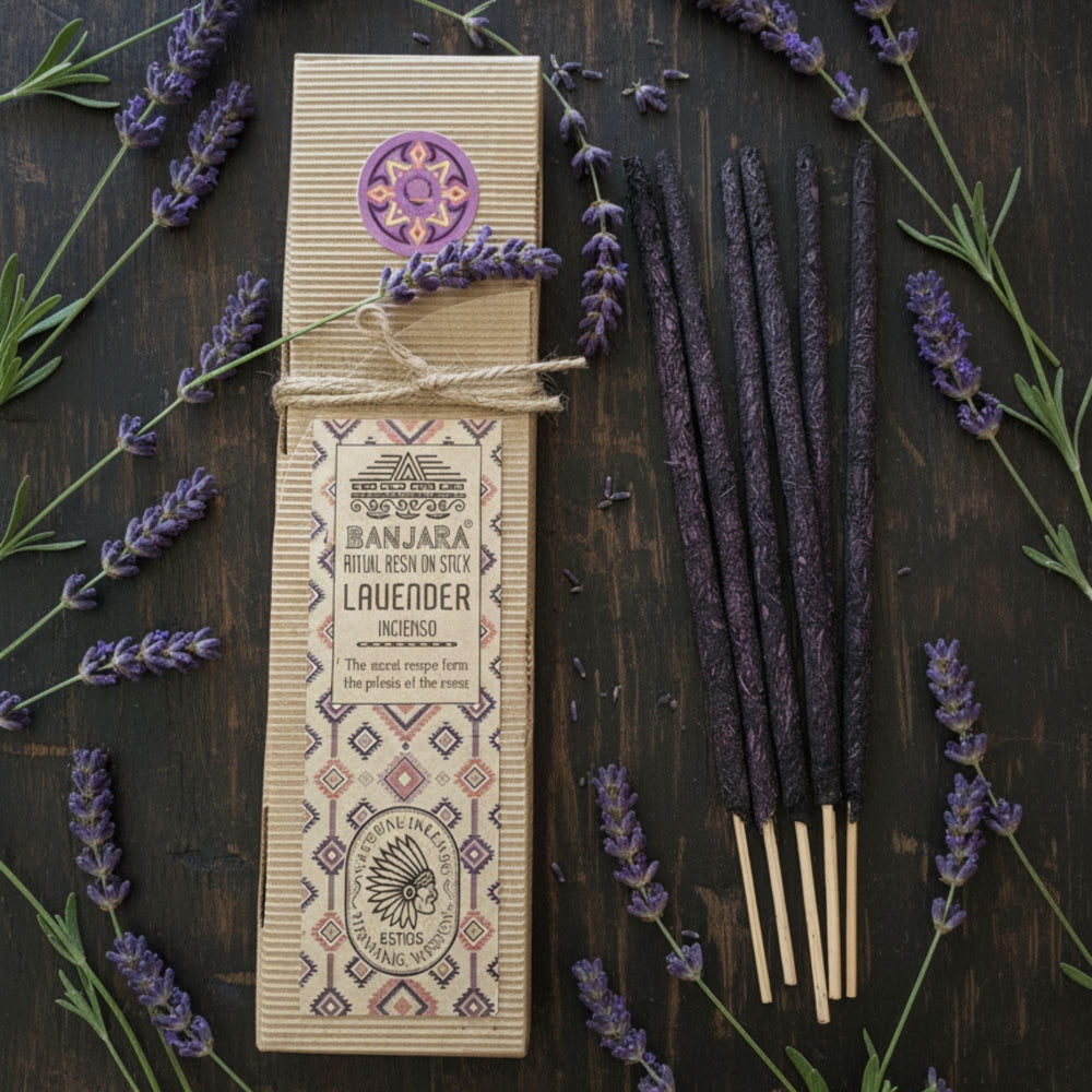 Banjara Lavender Incense sticks with packaging on a wooden surface surrounded by lavender flowers.