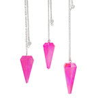 Three pink crystal pendant necklaces on a white background