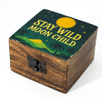 Wooden box with 'Stay Wild Moon Child' text and nature-themed design on a white background