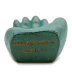Teal stone with 'Strength with Humility' engraving on a white background