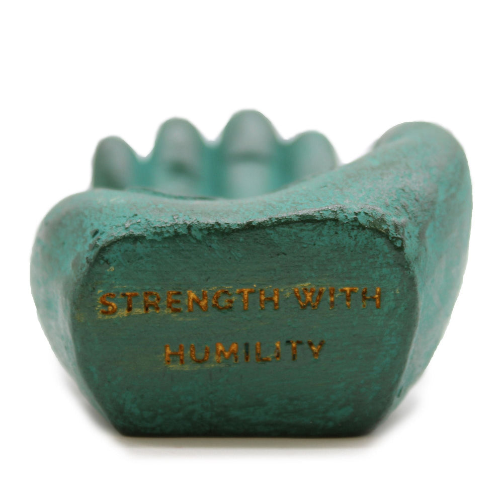 Teal stone with 'Strength with Humility' engraving on a white background