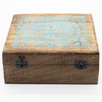 Wooden box with decorative blue pattern on a white background