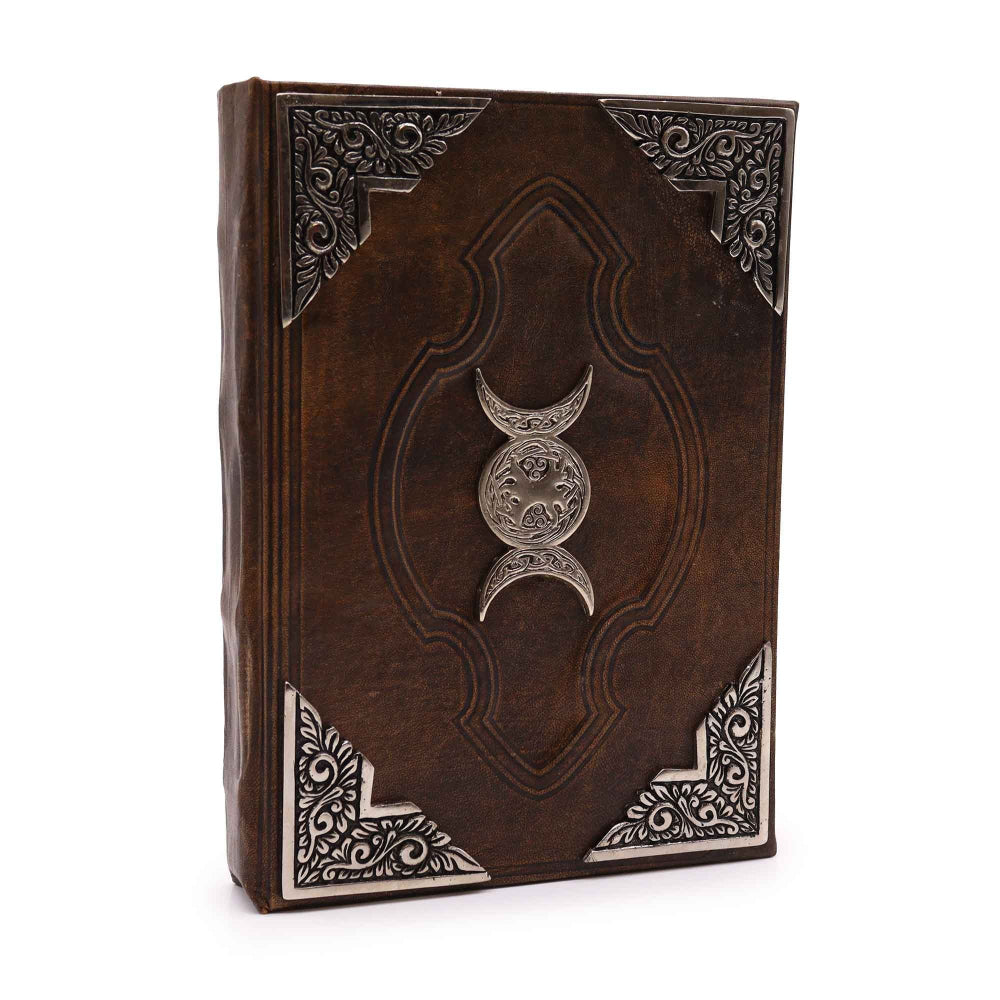Decorative leather book with embossed design and silver emblem on a white background