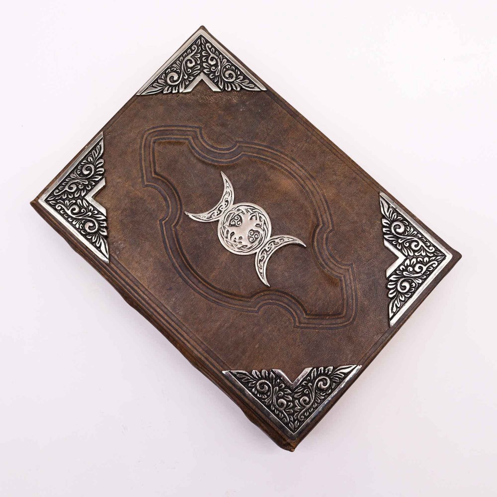 Decorative leather-bound book with embossed design on a white background