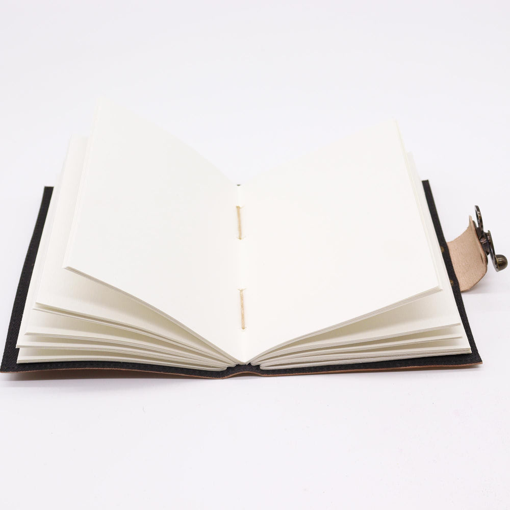 Open notebook with black binding on a white background
