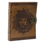 Brown leather journal with embossed face design and metal clasp on a white background