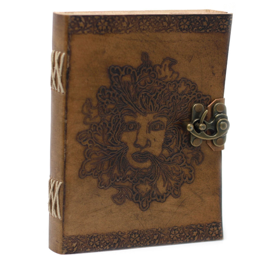 Brown leather journal with embossed face design and metal clasp on a white background