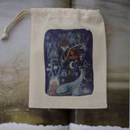 A cream-colored fabric drawstring pouch featuring a central square illustration of fantasy woodland characters in shades of blue, purple, and red, displayed on an open book.
