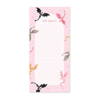 Notepad with dragon illustrations on a pink background