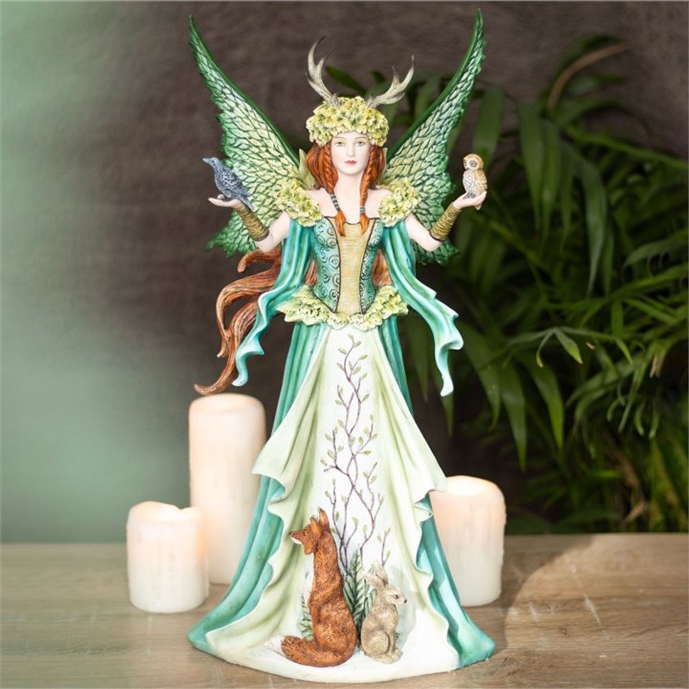A resin figurine of a green fairy with a bird perched on her shoulder, officially licensed by Amy Brown.